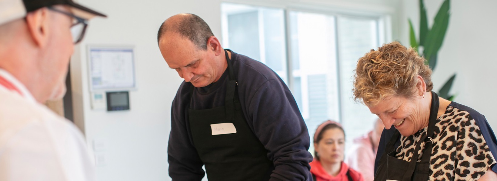 Two people in the kitchen cooking Two people in the kitchen cooking
