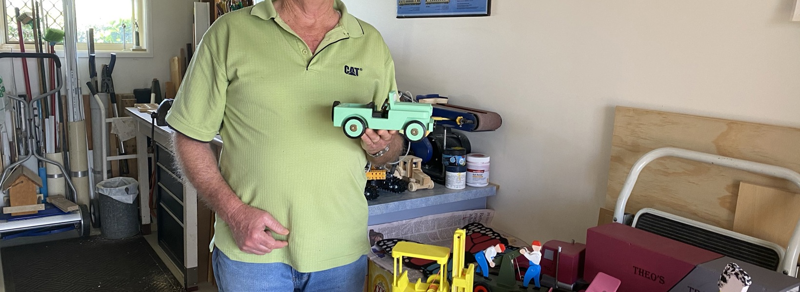 Dennis with toys in his workshop.JPEG Dennis with toys in his workshop.JPEG