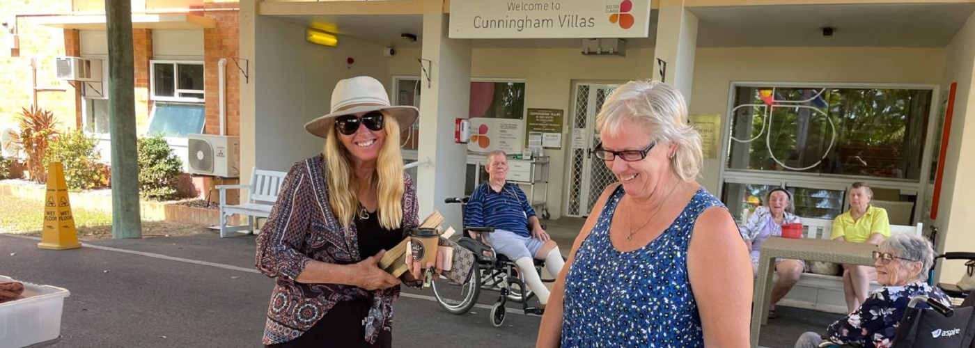 Two ladies smiling while shopping for secondhand books