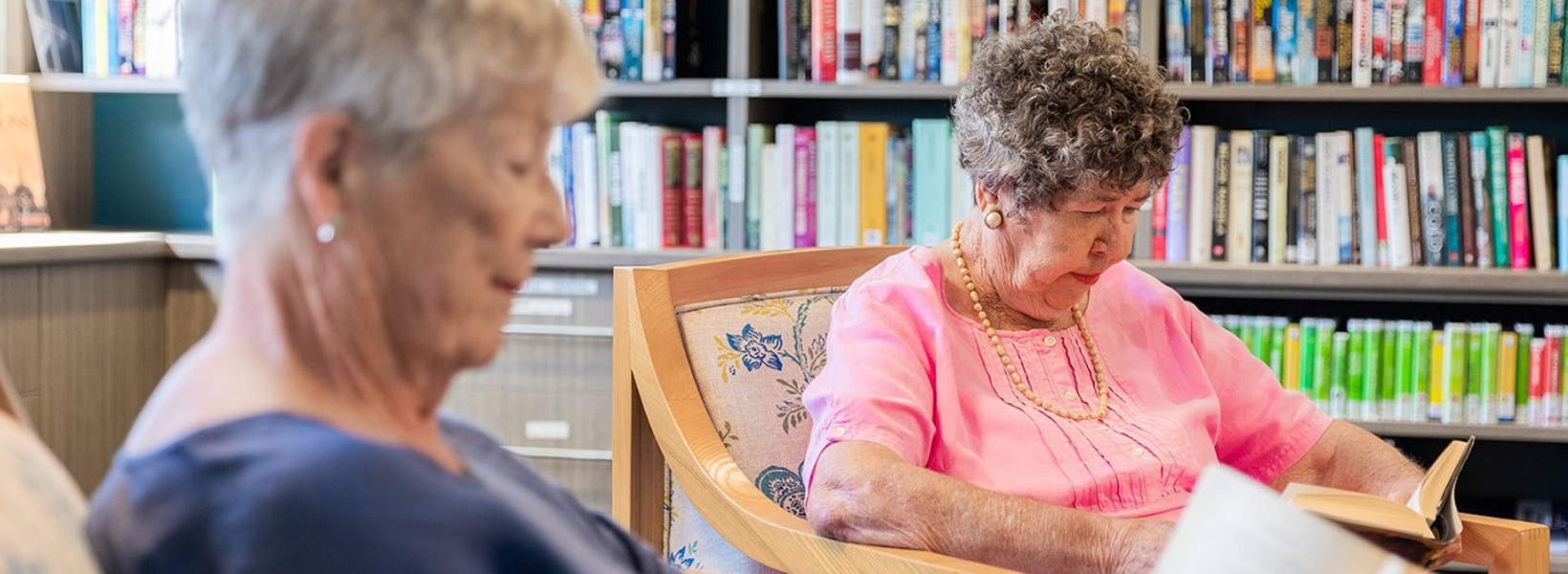 Two elderly females reading peacefully Two elderly females reading peacefully