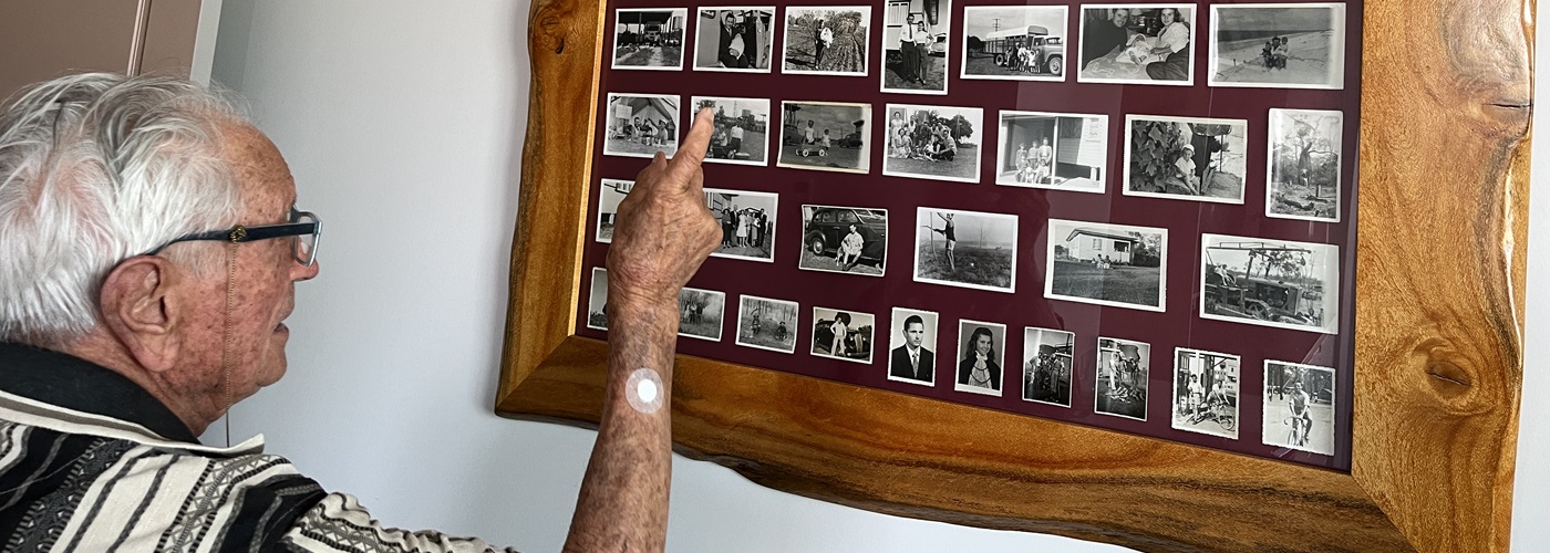 Frank looking through his photos from the early days of Caboolture.jpg
