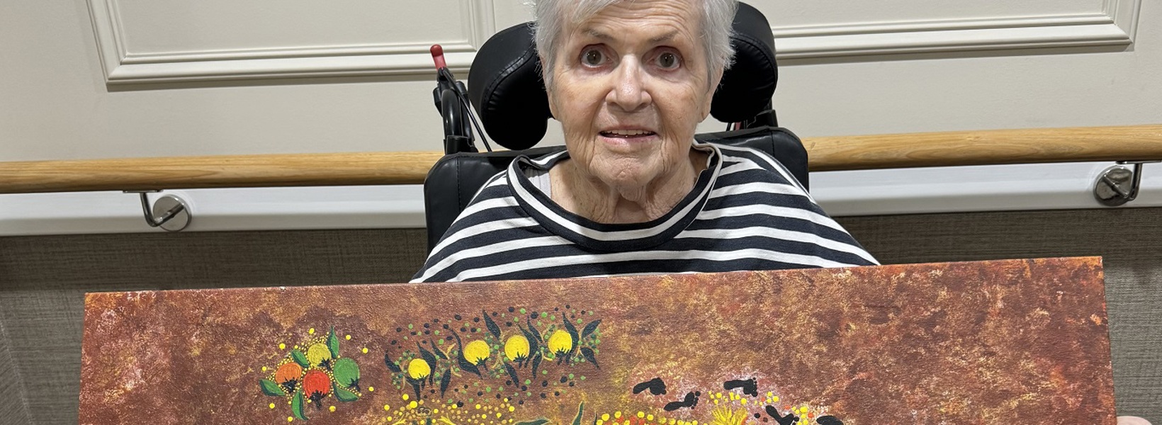 Jenny with one of her gifted paintings.jpg Jenny with one of her gifted paintings.jpg