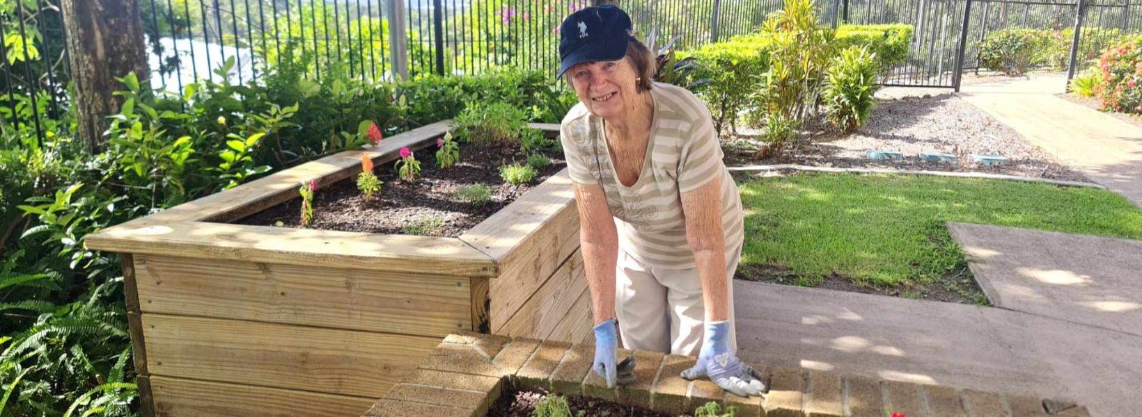 Resident Dianna tending to plants in the Buderim Views Goodness Garden.